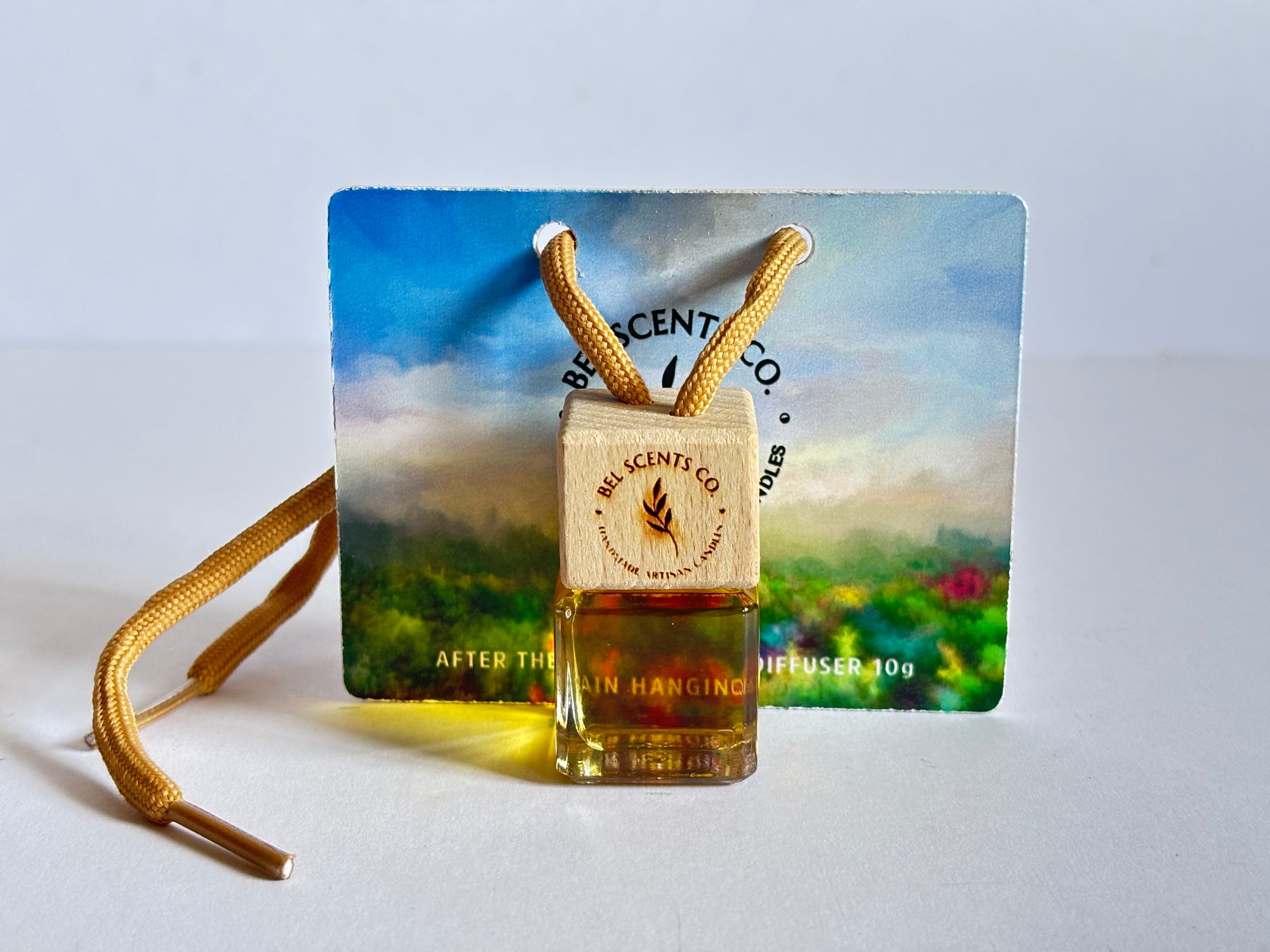 Extra Strong car fragrance. Scented hanging car diffuser bottle with wooden cap, suspended by string. Minimalist hanging diffuser for car interior. Hanging fragrance diffuser with Wood-topped diffuser adding a refreshing scent to a car interior. filled with essential oils for natural fragrance