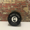 All-Natural Beard Balm for Men in Tin Container – Conditioning and Styling Balm with Essential Oils for Soft, Healthy Beard Care. Scented in Peru of Balsam Oil displayed on industrial brick wall setting 