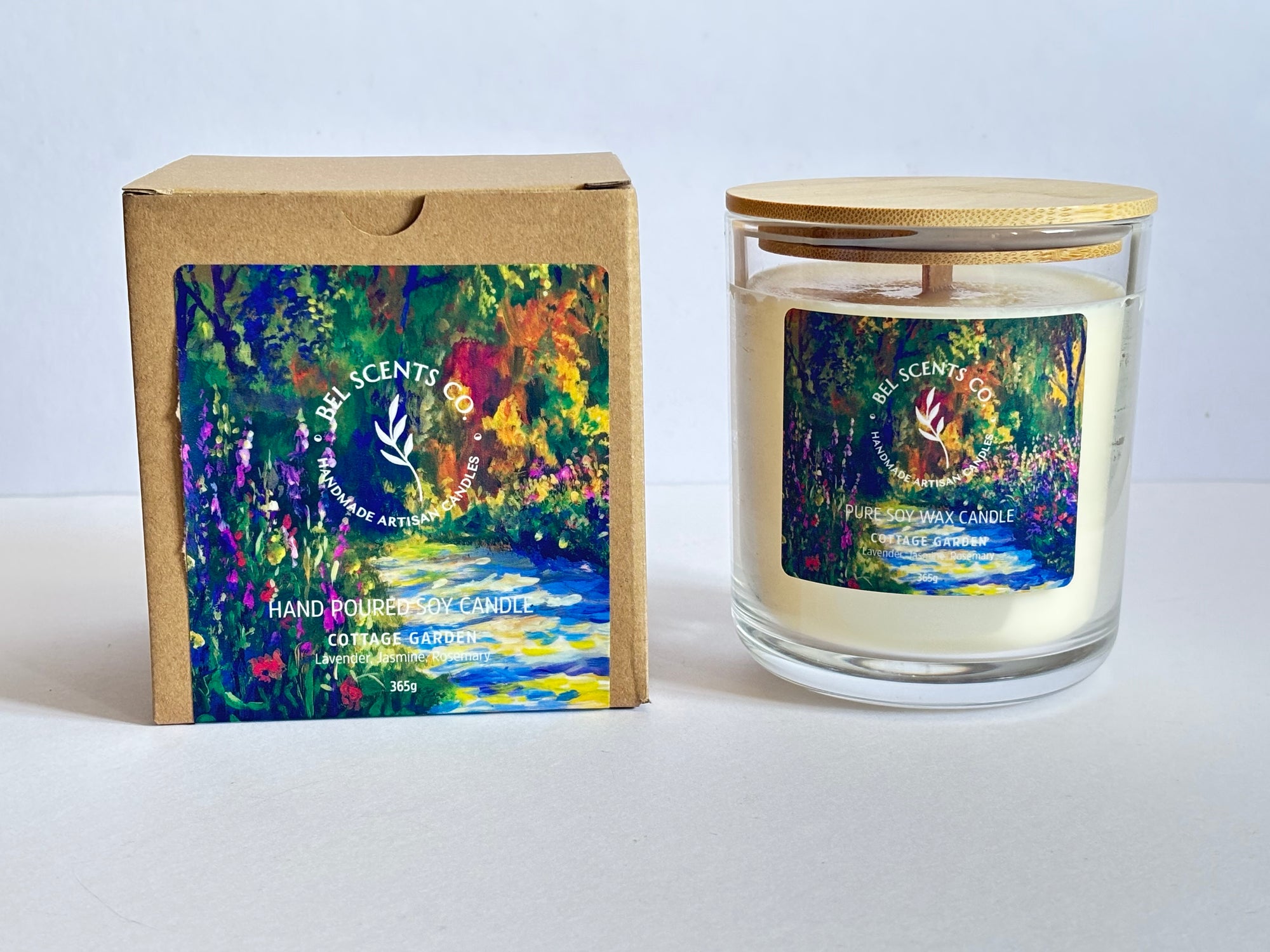 A soy candle with lavender and rosemary scents, packaged in a clear glass jar with a wooden-sealed lid, next to its colorful floral design box.
