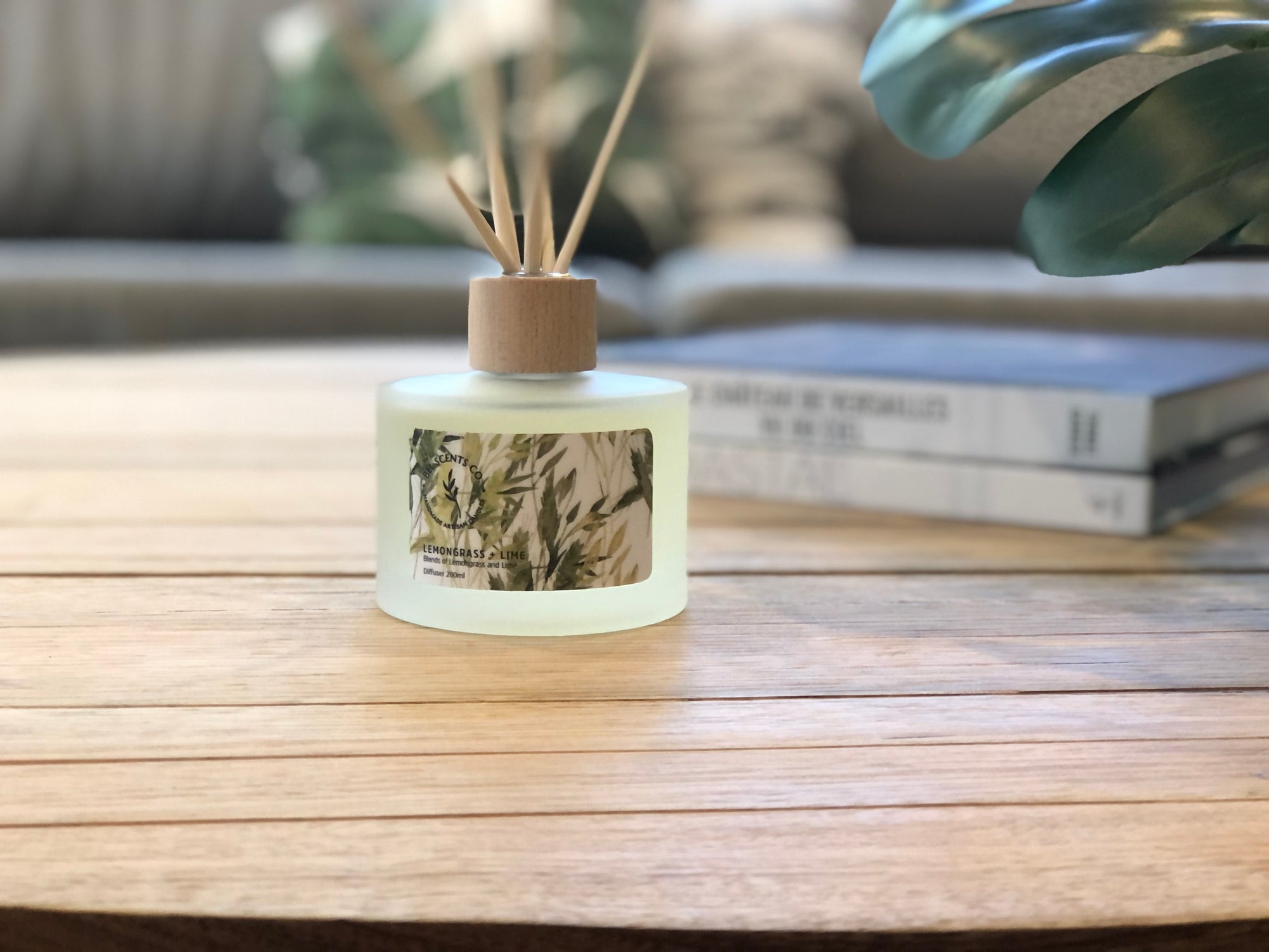Diffuser bottle with coastal vibe design on a wooden surface coffee table