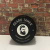 All-Natural Beard Balm for Men in Tin Container – Conditioning and Styling Balm with Essential Oils for Soft, Healthy Beard Care. Scented in Peru of Balsam Oil displayed on industrial brick wall setting 